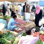 People purchasing vegetables at Bachhat Bazzar, Lines Area