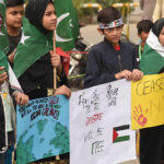 Participants in the solidarity rally with Palestine organized by Majlis Wahdat Muslimeen at Mall Road