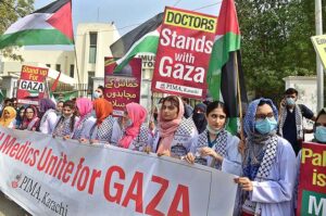 Doctors and paramedics hold placards during a pro-Palestinian rally organized by Pakistan Islamic Medical Association PIMA at Jinnah hospital