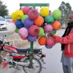 A vendor is selling and displaying colorful nests to attract customers