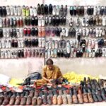 Vendor displaying old shoes at Old Bus Stand Road