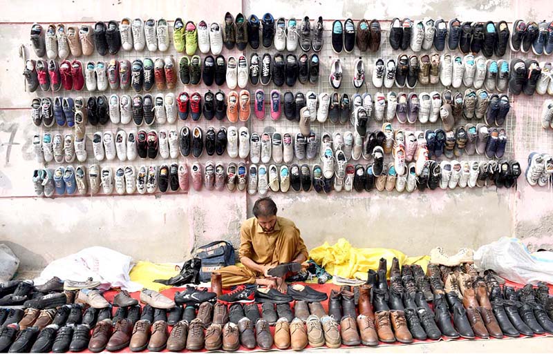Vendor displaying old shoes at Old Bus Stand Road