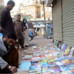 People selecting and purchasing used books at Reagal Ch Cowk.