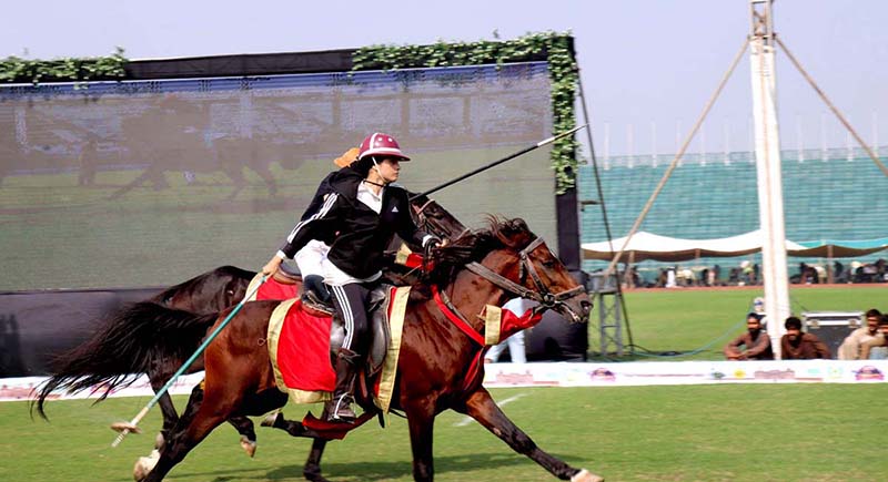 A lady horse rider successfully achieves her target in the tent pegging competition at the inaugural ceremony of the Chief Minister Tent Pegging Championship 2023 "Lahore Lahore Aey" Festival organized by the Parks and Horticulture Authority at Fortress Stadium
