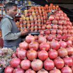 A vendor selling fruits at his roadside setup