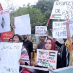 Students hold placards as they protest against the Israel and to show support for the people of Palestine at Karachi Press Club