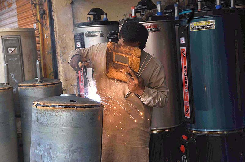 A worker busy in making gas geyser at Mian Mir Road