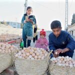 A school-going age boy selling eggs to support its family at a roadside near Koyla Patkha