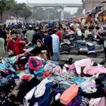 A large number of People selecting and purchasing second hand warm clothes and different winter stuff from the vendors at Landa Bazar