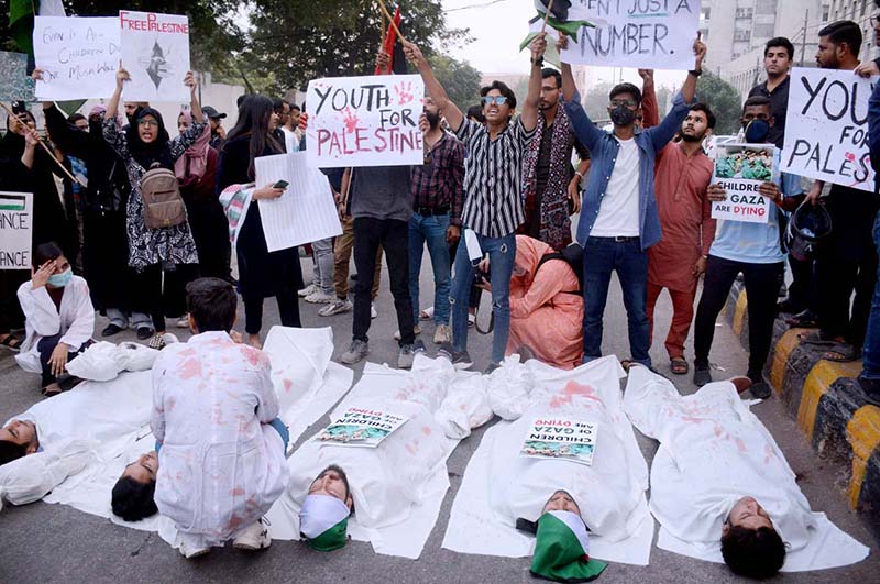 Students hold placards as they protest against the Israel and to show support for the people of Palestine at Karachi Press Club