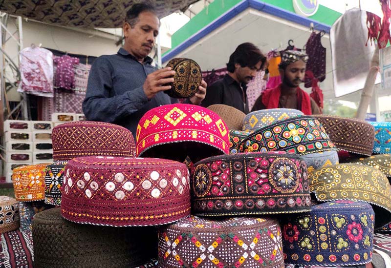 People purchasing Sindhi caps in connection with upcoming Sindhi Ajrak Topi Culture Day at Royal Road.