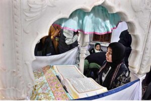 A Sikh woman yatree performing her religious rituals on the occasion of 554th birth anniversary of Guru Nanak Dev in Nankana Sahib, Guru Nanak was the founder of the religion of Sikhism and the first of ten Sikh Gurus. His birth is celebrated worldwide as Guru Nanak Gurpurab on Kartik Pooranmashi, the full-moon day in the month of Katak, October–November