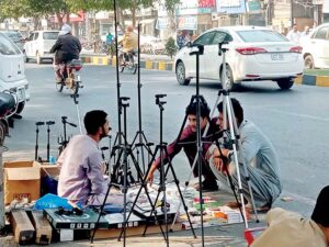 A man is purchasing handmade sparrow grass nests from roadside stall