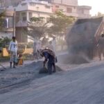 Women laborers working on Khawaja Road, construction project
