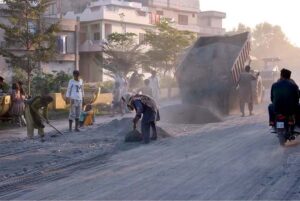 Women laborers working on Khawaja Road, construction project