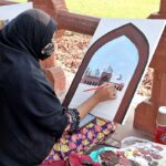 Artist giving final touch to painting in Dewane Aam Painting Competition inside Shahi Fort in collaboration with Bab Pakistan Foundation and Walled City Authority Lahore
