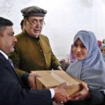 Governor Gilgit-Baltistan Syed Mehdi Shah distributing gifts among the children during his visit Sweet Home