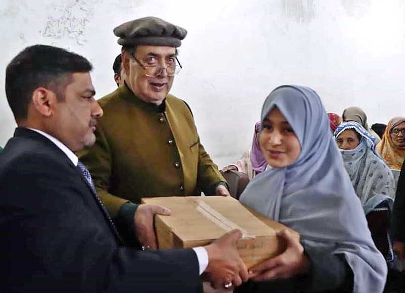 Governor Gilgit-Baltistan Syed Mehdi Shah distributing gifts among the children during his visit Sweet Home