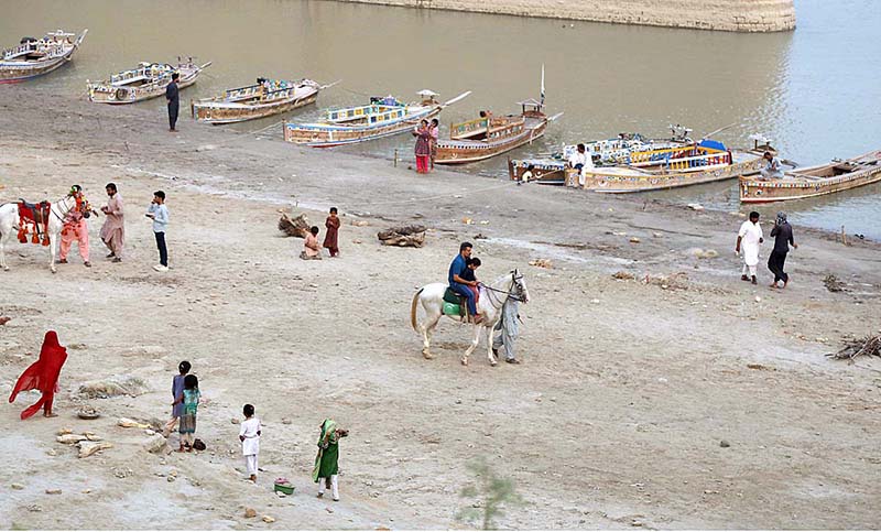 Families enjoying at bank of Indus River