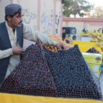 A vendor arranging dates for selling on his cart to attract costumers customers near Science College