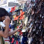 A youngster selects sunglass from road side setup
