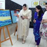 Women taking keen interest in display stuff during an art exhibition at SBBWU