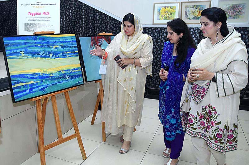 Women taking keen interest in display stuff during an art exhibition at SBBWU