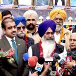 Shiromani Gurdwara Parbandhak Committee (SGPC) Amritsar Jatha Leader Khushminder Singh talking to media persons after arriving in Pakistan through Wagha Border to participate in religious rituals on the occasion of 554th Birth Anniversary of Guru Nanak at Nankana Sahib