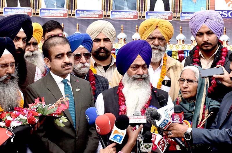 Shiromani Gurdwara Parbandhak Committee (SGPC) Amritsar Jatha Leader Khushminder Singh talking to media persons after arriving in Pakistan through Wagha Border to participate in religious rituals on the occasion of 554th Birth Anniversary of Guru Nanak at Nankana Sahib