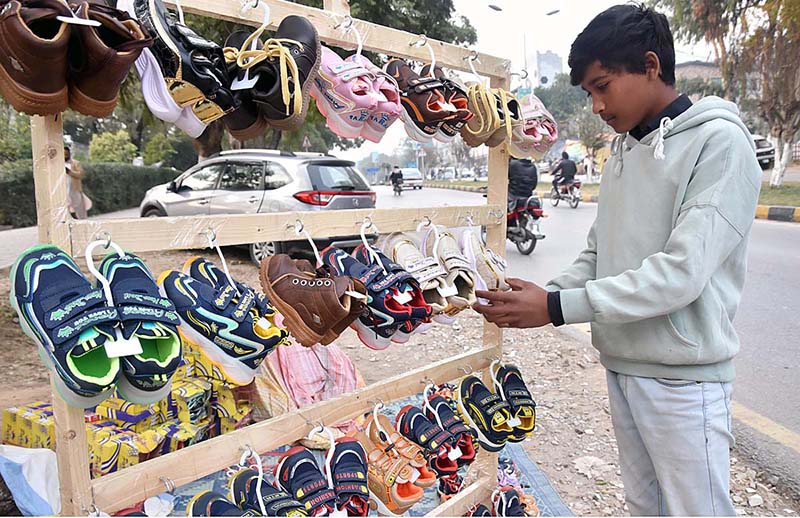 A vendor selling and displaying shoes at G-7