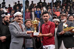 Secretary Forest Gilgit-Baltistan Zafar Waqar Taj giving away trophy to the player of the match during the final match of the Jashan-e-Azadi free polo tournament at Aga Khan Shahi polo ground