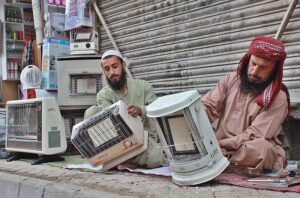 Man repairs gas heater at main Quetta bazaar