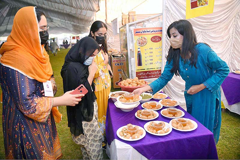 Female students purchasing traditional food item "Gol Gappey' from the stall during second day of First Dosti Women Literature Festival, 1st Edition at SBBWU