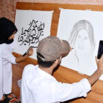 Students giving final touch to their artwork during literature festival in connection with world Children’s day at Basant hall