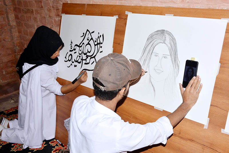 Students giving final touch to their artwork during literature festival in connection with world Children’s day at Basant hall