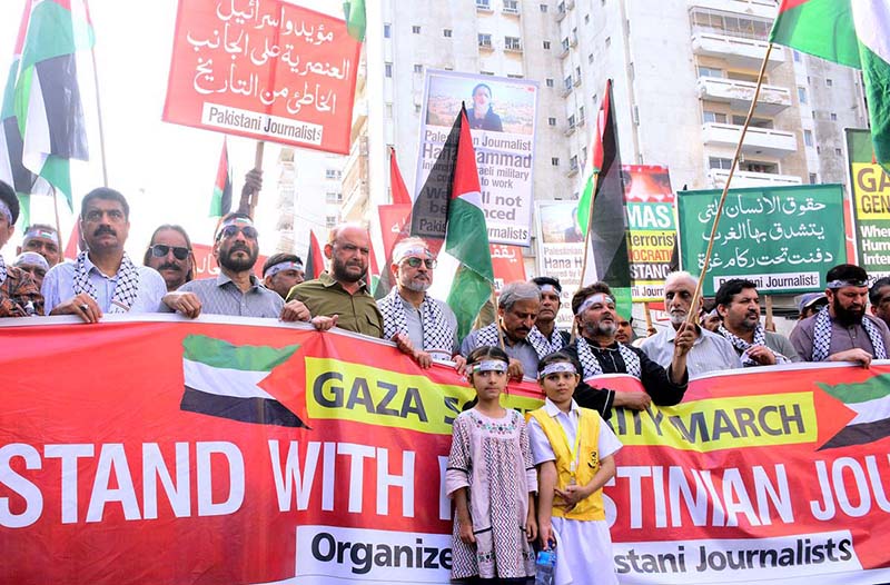 Journalists holding playcards during a rally in support of Palestinians, and express solidarity with Palestinian journalists and their families during Gaza March (Save Gaza Save Journalists) at the Karachi Press club to Governor House Sindh
