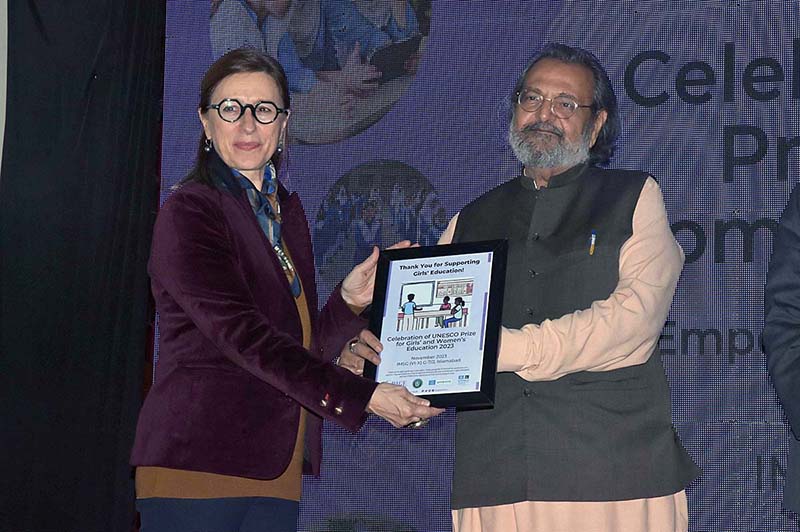 Caretaker Federal Minister for Education and Professional Training Madad Ali Sindhi, giving away shields to the participants during celebration of UNESCO prize for Girls' and Women's Education 2023 Empowering Girls Through Education at IMSG (VI-X) G-7/2
