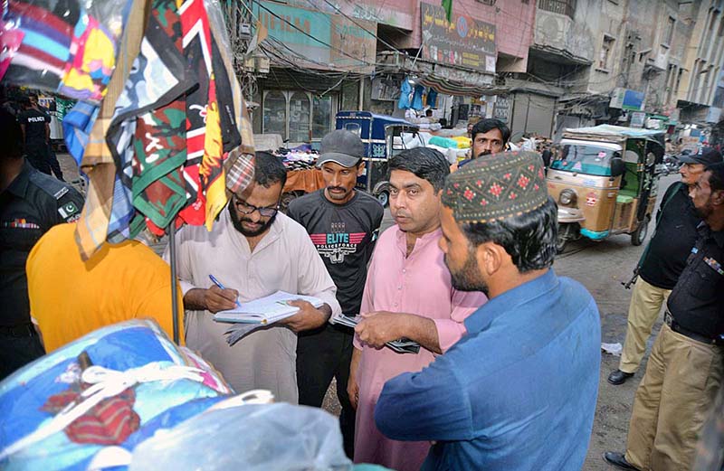 Police personnel checking NADRA identity cards of foreign migrants in different areas