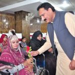 Deputy Director NCHD Mehar Umar Daraz Ghauri giving a flower to a Special woman during an event on world Disability Day organized by DC welfare in a local hotel