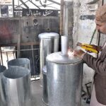 A worker busy in making geyser at his shop as its demand increased during winter season.