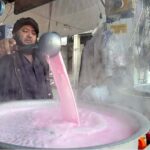 A vendor busy in making Kashmiri tea for customers at his roadside setup at Aabpara Market