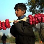 A young vendor selling floral bangles to attract customers at F9 Park in the Federal Capital