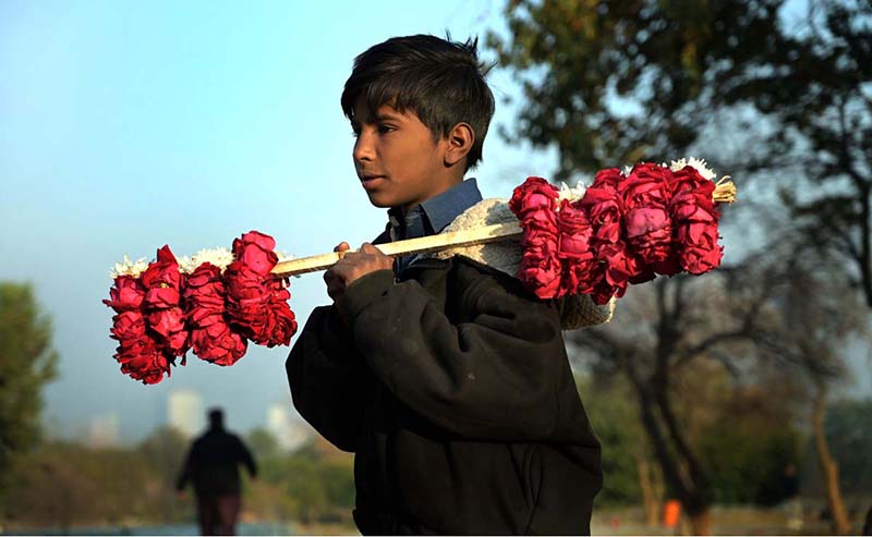 A young vendor selling floral bangles to attract customers at F9 Park in the Federal Capital