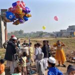 A street vendor dislaying different kinds of balloons to attrrat children at Tramri Chowk