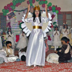 Students performing tableau on the stage during Christmas program in connection with upcoming Christmas at local church.