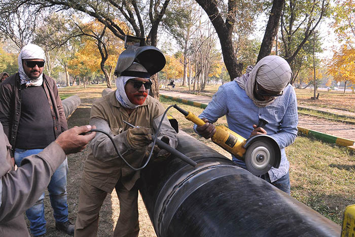 SNGPL staffers busy welding gas pipeline during installation at G-7 area in the Federal Capital.