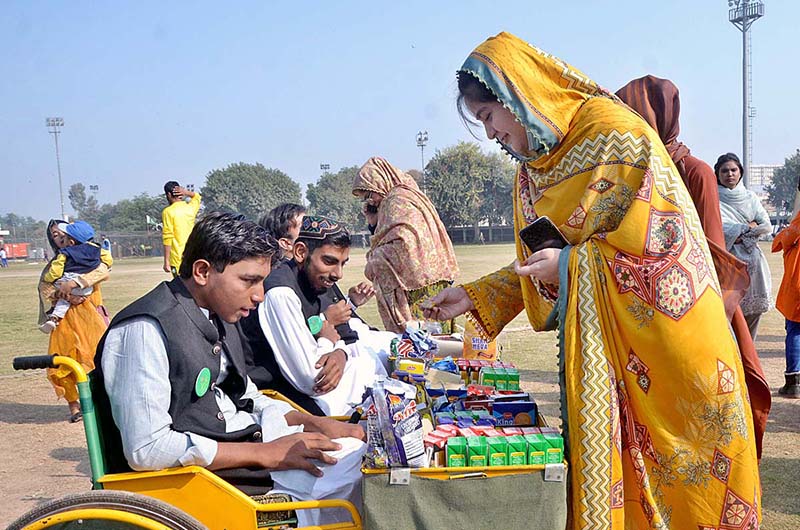 Visitor girl purchasing food items from the stall during the Special Sports Festival to mark International Day of Persons with Disabilities