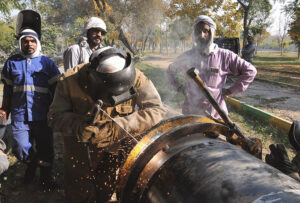 SNGPL staffers busy welding gas pipeline during installation at G-7 area in the Federal Capital.