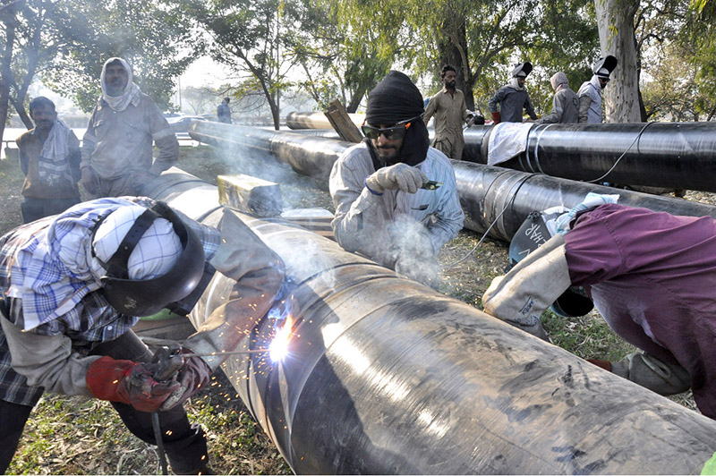 SNGPL staffers welding gas pipes installing at Zeropoint area in federal capital