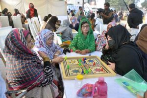 Visitor girl purchasing food items from the stall during the Special Sports Festival to mark International Day of Persons with Disabilities